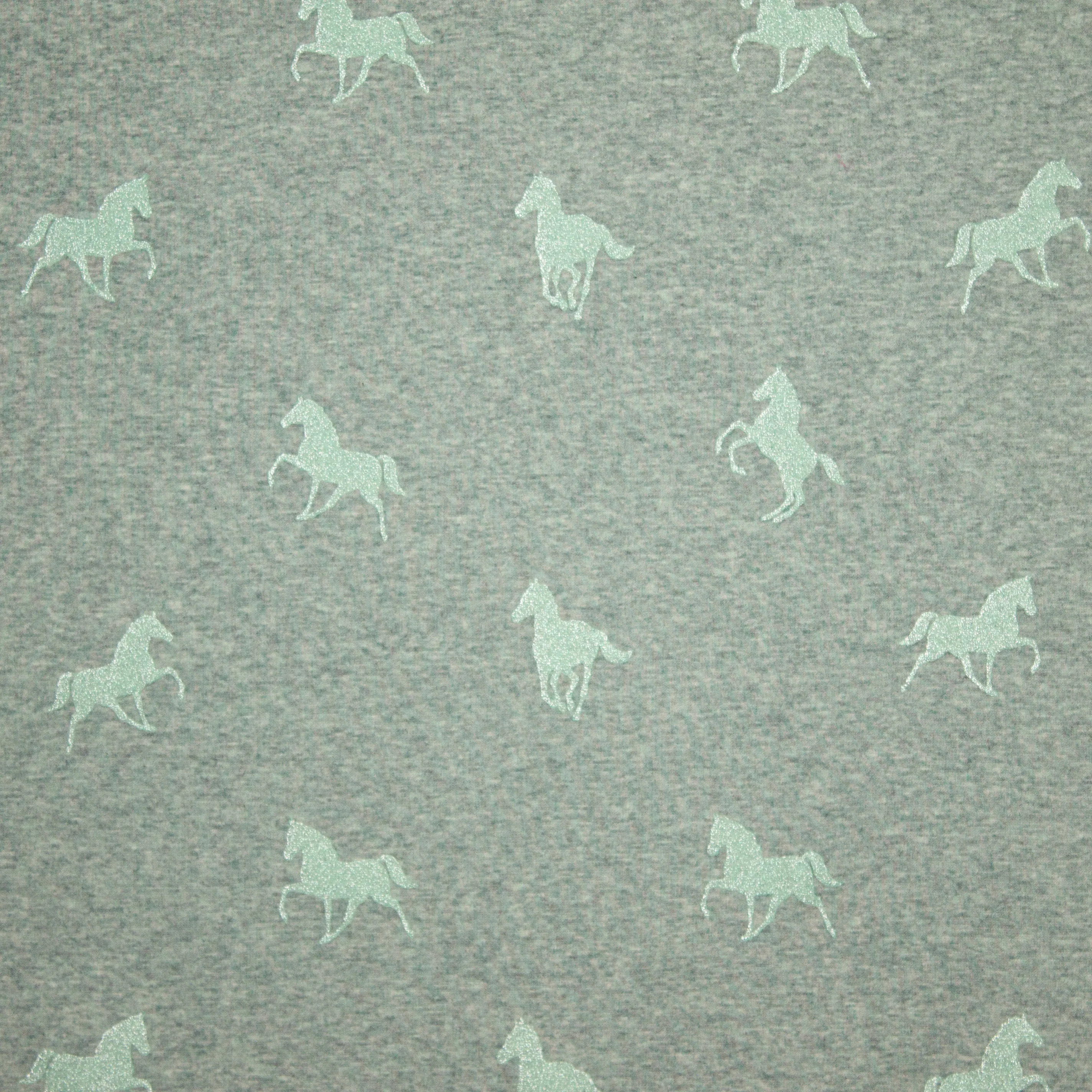 Sweaterstof met muntgroene glitterpaardjes